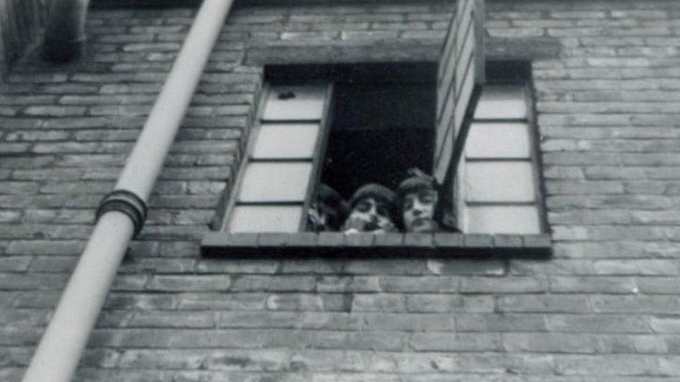 Beatles looking out of Rialto window