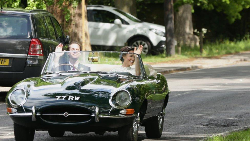 Pippa Middleton and James Matthews wave as they drive a Jaguar E-Type after their wedding