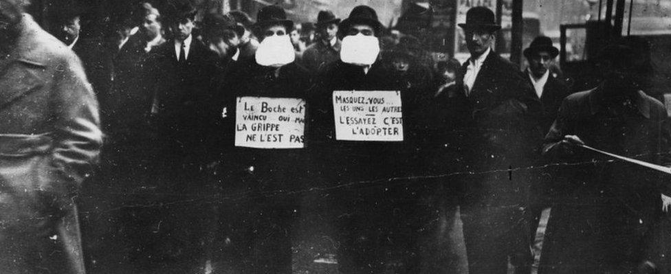 Two men wearing flu masks in Paris