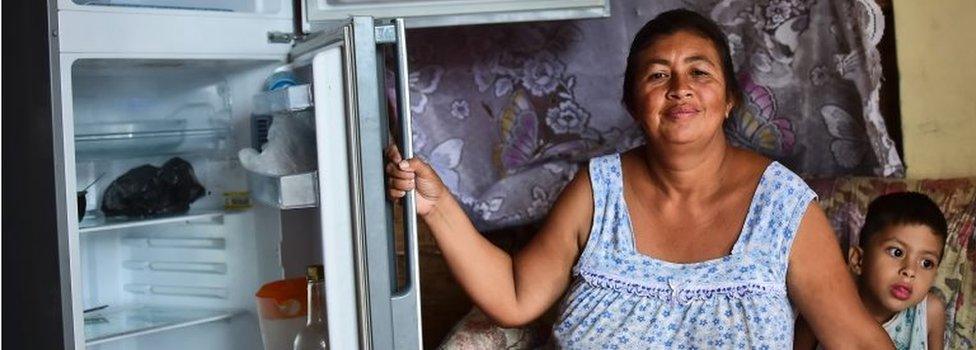 Liliana Rojas shows her empty refrigerator at her home in the poor neighbourhood of Catia, Caracas, June 2, 2016.