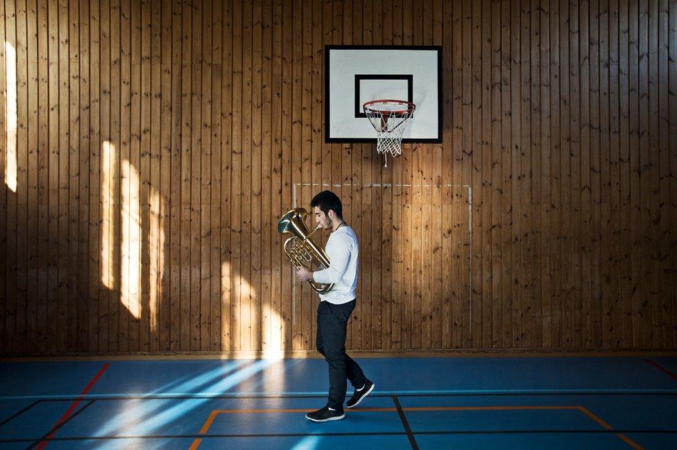 A boy practices his trombone