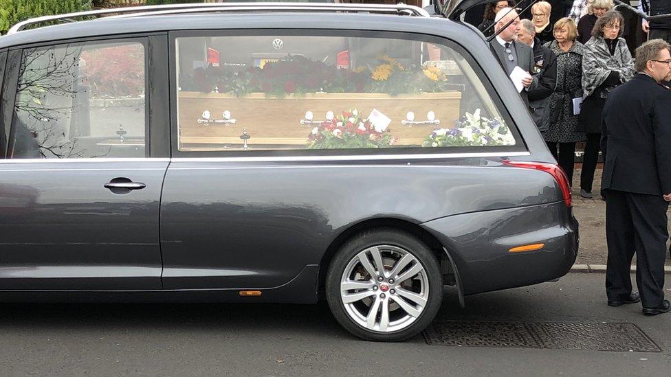 Re Buttress' coffin in the funeral car