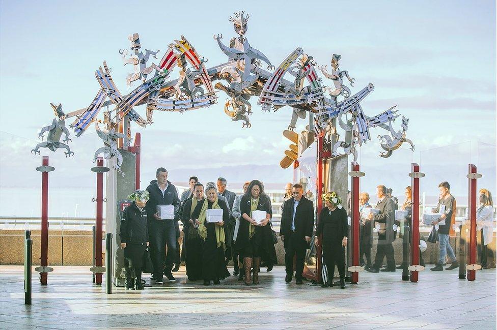 A welcoming ceremony at Te Papa with whānau (family) carrying their tūpuna (ancestors), May 2017