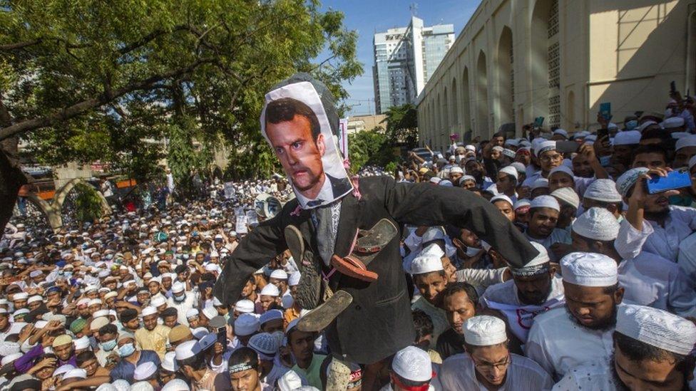 Members and supporters of several Islamist political parties hold an effigy of French President Macron in Dhaka