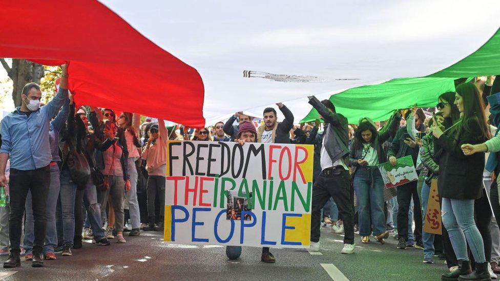 People take part in solidarity protest on September 25, 2022, in Paris