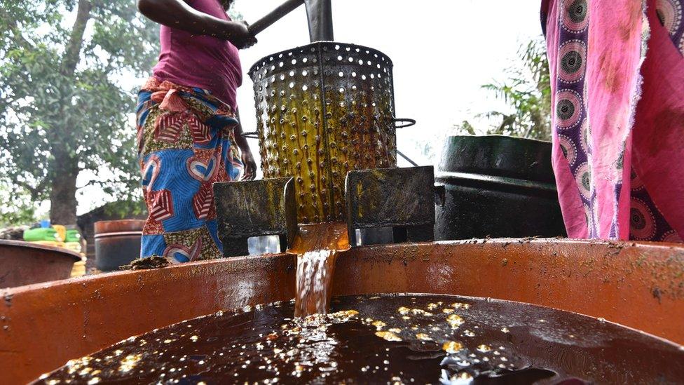 Woman making palm oil