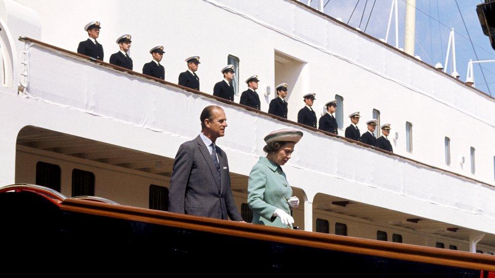 Queen Elizabeth II and the Duke of Edinburgh disembarking from the Royal Yacht Britannia in Portsmouth Dockyard in 1977