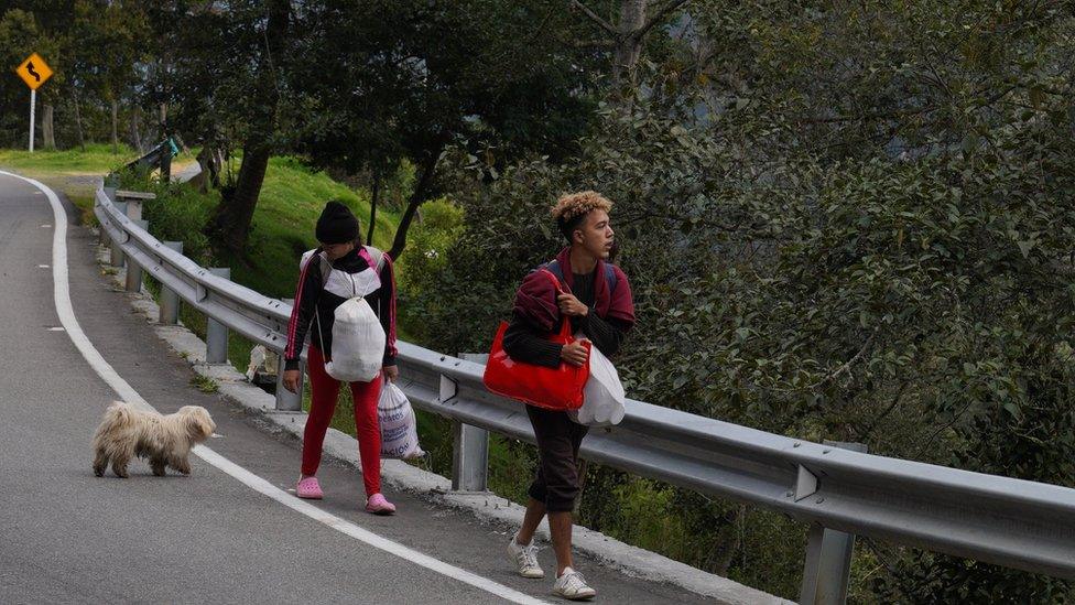 Ángel Garcia and his partner Daniela Segueri walking on the road between Pamplona and Bucaramanga Colombia on 1 October.