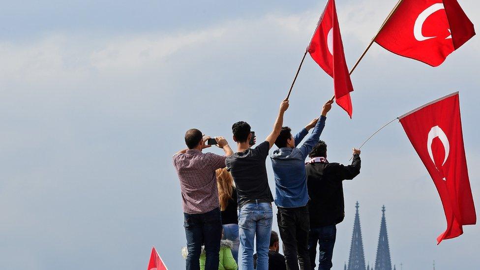 Supporters of Turkish President Recep Tayyip Erdogan rally at a gathering on July 31, 2016 in Cologne, Germany