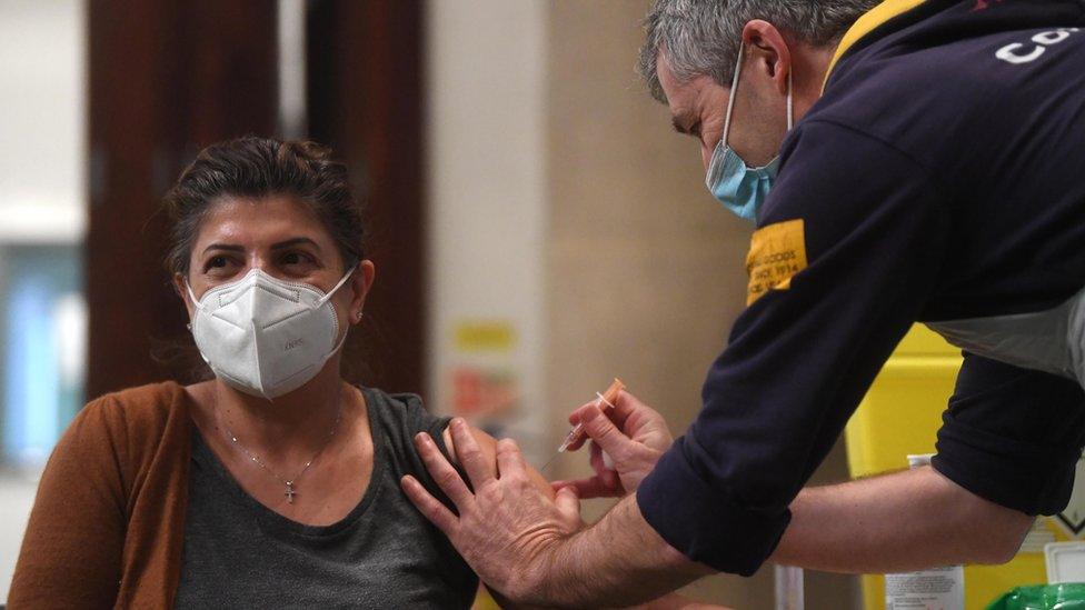 A woman receives the Oxford/AstraZeneca Covid19 vaccine at an NHS vaccination centre in Ealing, west London