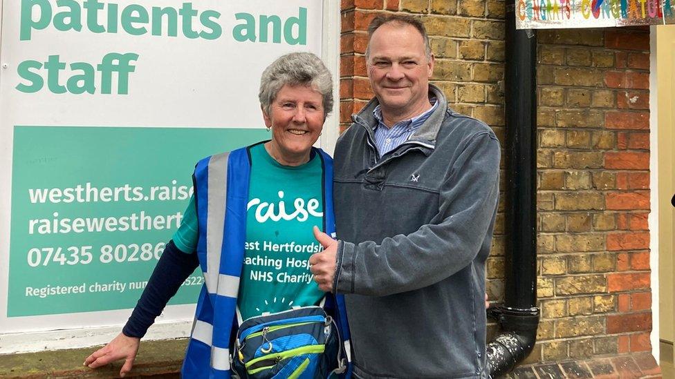 Linda Pottinger smiling with surgeon Drostan Cheetham who has a thumbs up