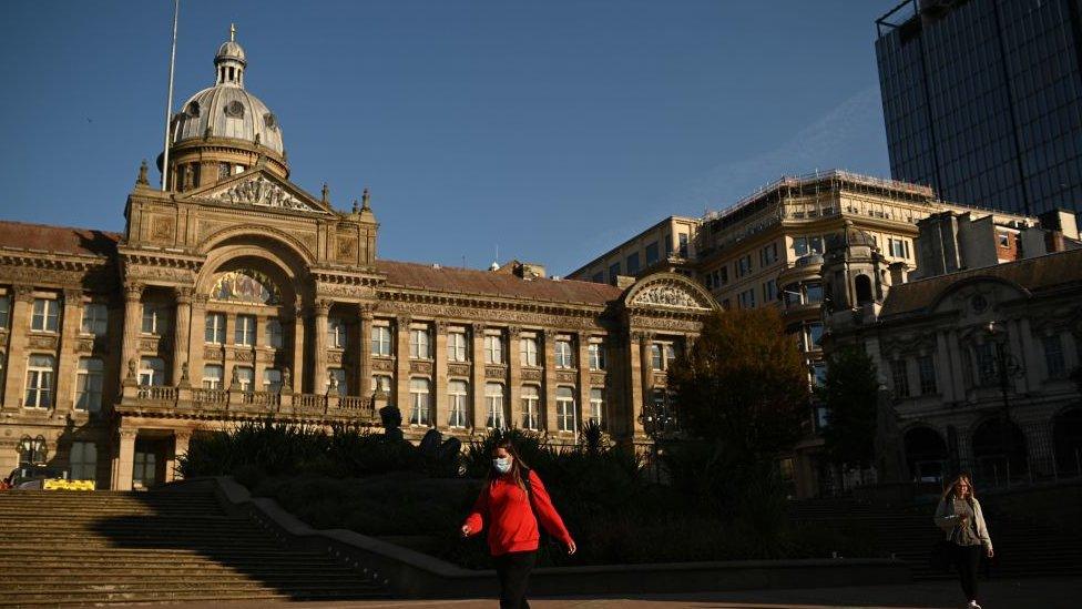 A woman walks past Birmingham's town hall