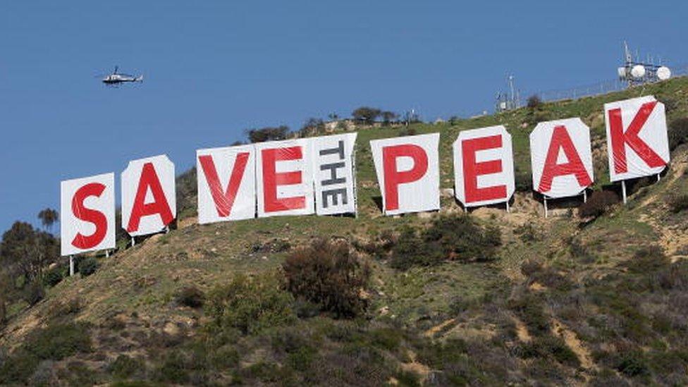 The Hollywood Sign covered with "SAVE THE PEAK"