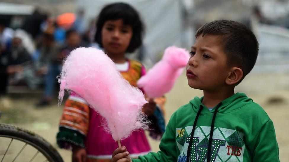 Afghan children enjoy candy floss during last year's Nowruz festival in Kabul