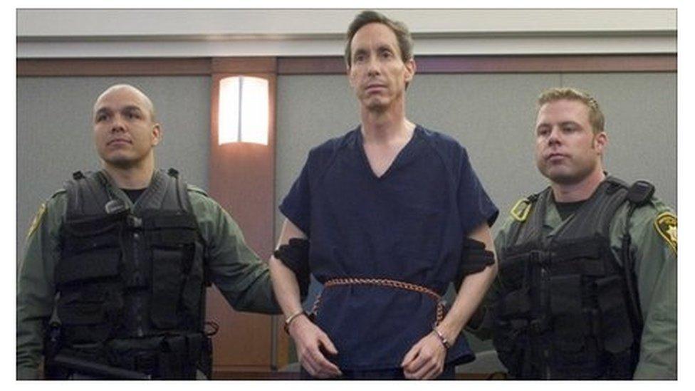 Police holding the arms of Warren Jeffs