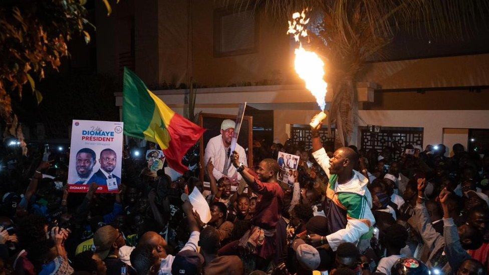 Supporters of opposition politician Ousmane Sonko celebrate his release outside his home in Dakar, Senegal, 15 March 2024.