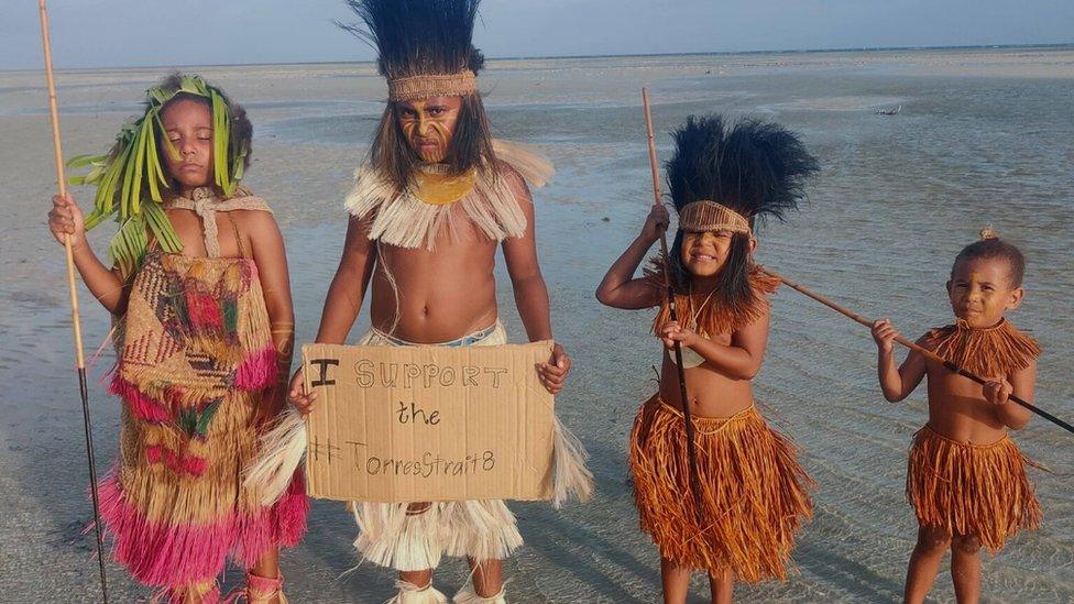 Children standing on a beach