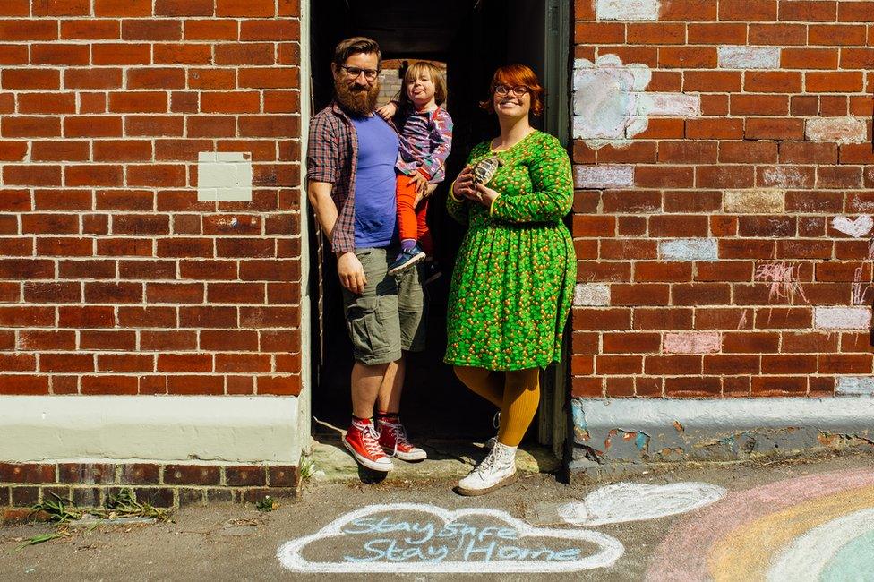 Doorstep portrait of Chris, Charlie and Lyra in Heeley