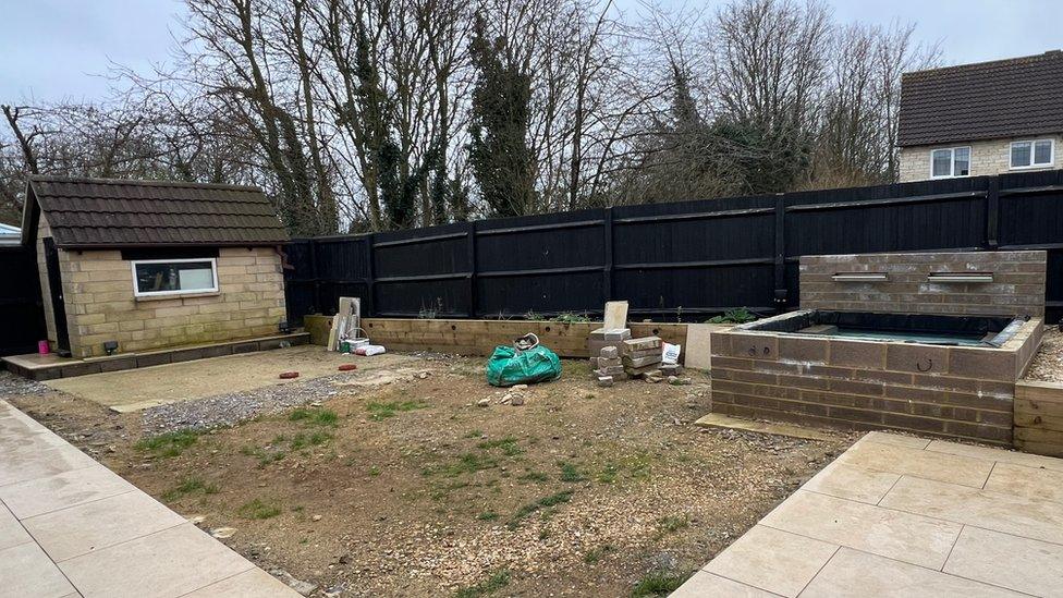 Mr and Mrs Hall's garden in an unfinished state with stone everywhere