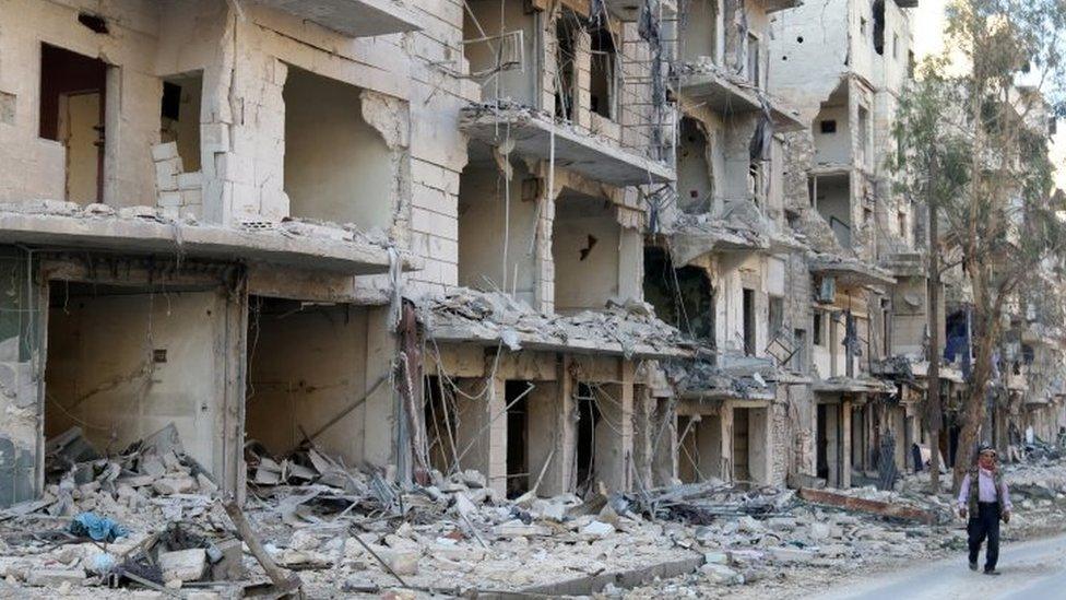 A man walks past damaged buildings in the rebel held besieged al-Sukkari neighbourhood of Aleppo. Photo: 19 October 2016