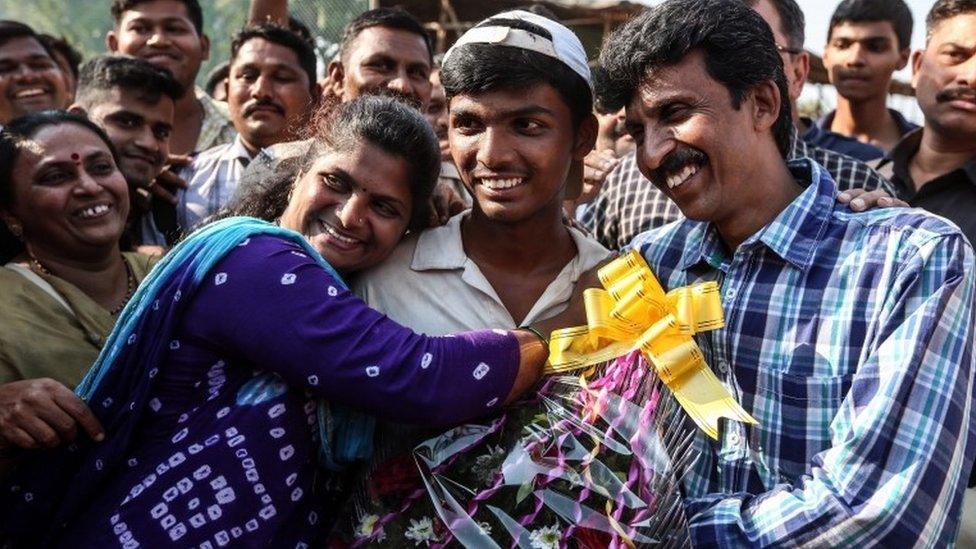 Pranav Dhanawade (C) celebrates his 1000 runs innings with his father Prashant Dhanawade (R) and Mohini Dhanawade (2-L) after HT Bhandari Cup inter-school tournament, in Kalyan outskirts of Mumbai, India, 05 January 2016