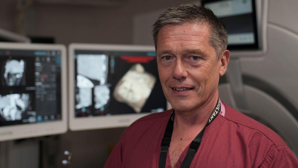 Dr Simon Smith in front of radiology computers.