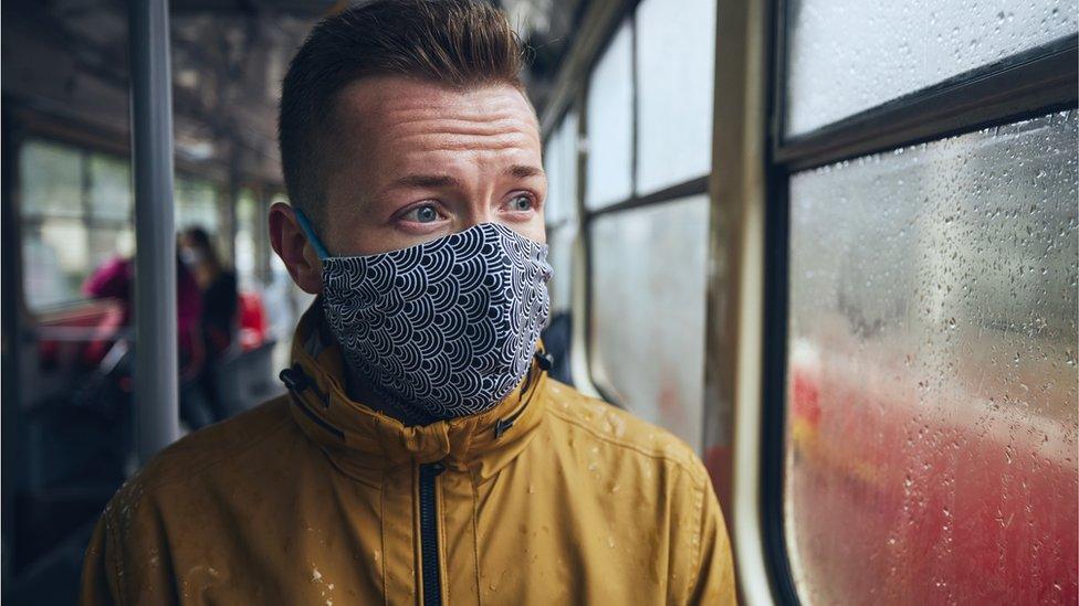 man on bus with face mask