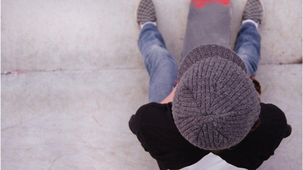 A boy sitting on steps