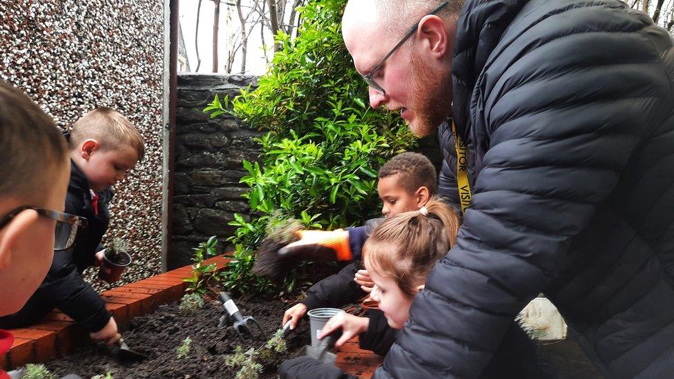 Image of children working with Angus to create a Wild Space