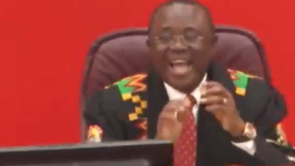 Person laughing in Ghana's parliament