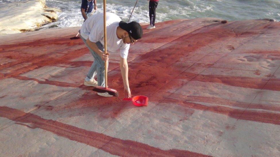 A handout photo made available by Soprintendenza ai Beni Culturali di Agrigento shows technicians and volunteers working to remove red stains from the defaced Scala dei Turchi (Stair of the Turks) in Realmonte, Italy