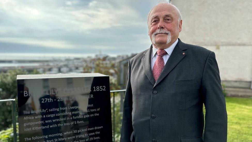 Tony Brown by the plaque