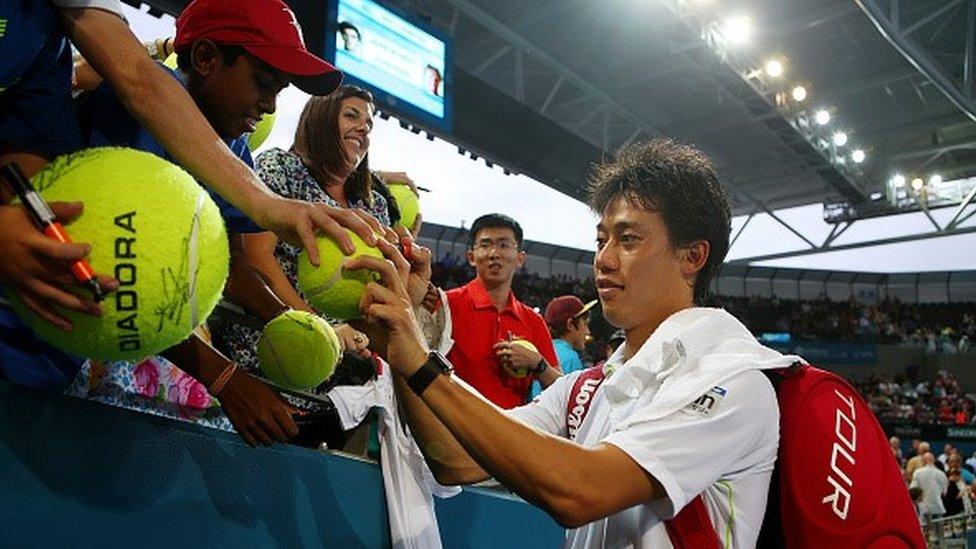 Kei Nishikori of Japan signs autographs at the ATP tournament in Brisbane in 2015