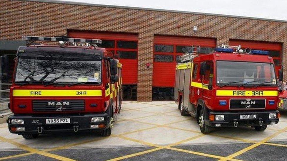 Two fire engines outside a fire station