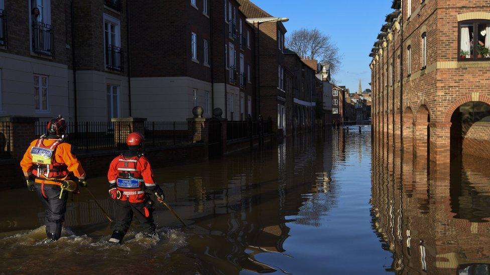 Rescue crews walking in Skeldergate, York, on 29 December