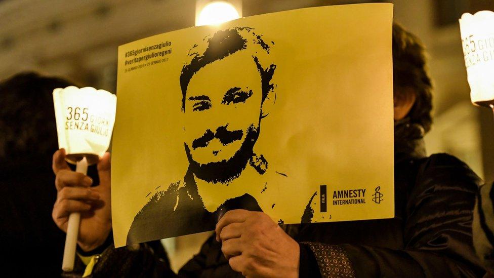 Activists of human rights organization Amnesty International hold a picture of Giulio Regeni on 25 January 2017