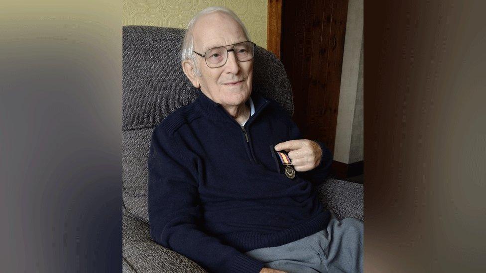 Bob Last holding his Nuclear test medal