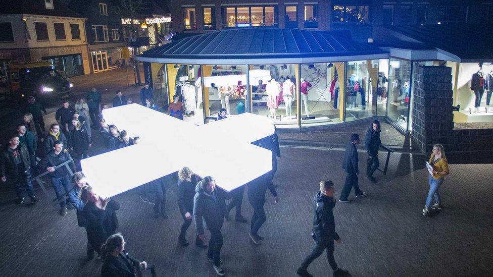 Volunteers rehearse carrying the white cross for the performance of the TV program 'The Passion', which will be broadcast on the public broadcaster, in Doetinchem, Netherlands, 12 April 2022.