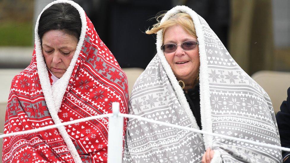 Two women wrapped in blankets