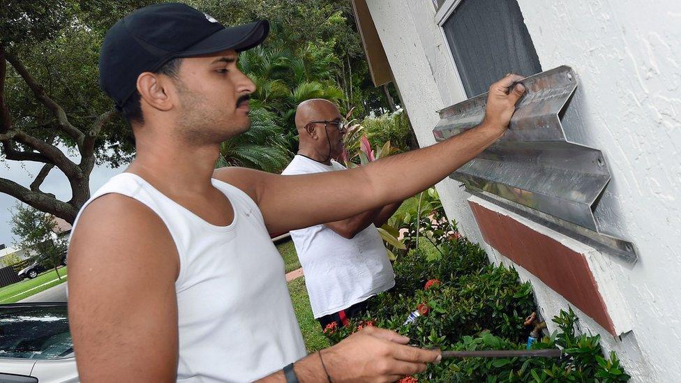 Miami homeowners put up shutters in preparation of Hurricane Matthew in Miami, Florida on October 6, 2016.