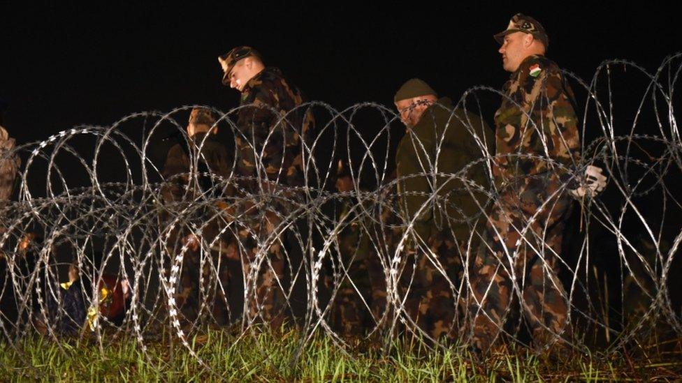 Hungarian police and soldiers close the border between Hungary and Croatia with barbed wire and a fence in Botovo on October 16, 2015.