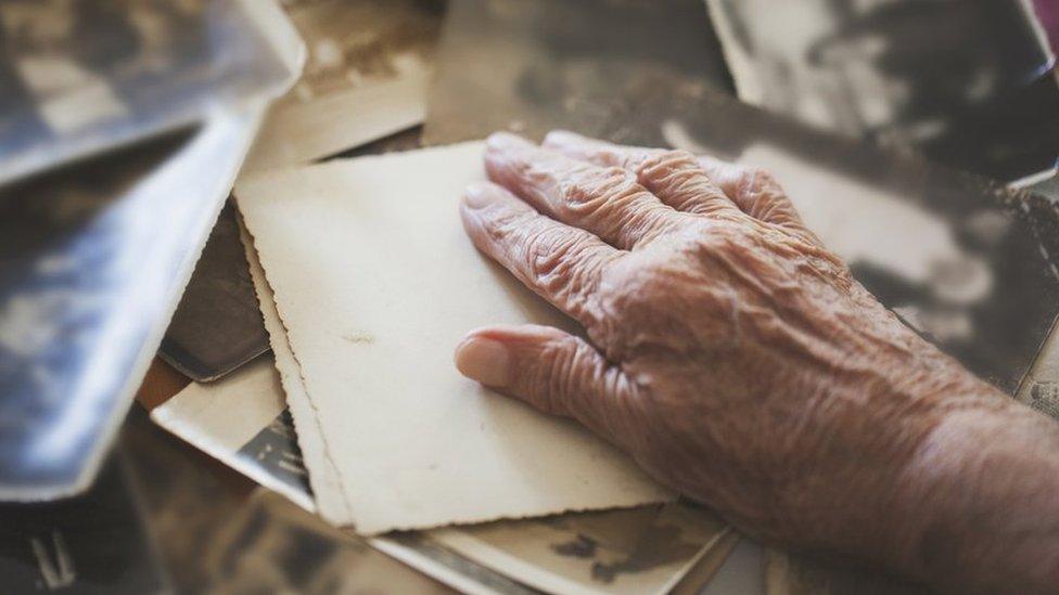 Hand with old photographs