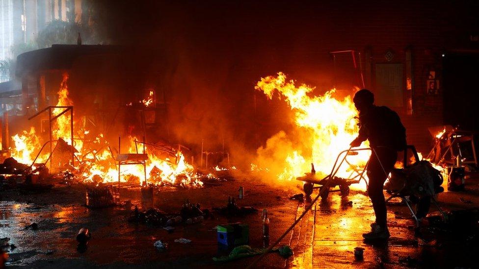 A protester trying to extinguish a fire at Hong Kong's Polytechnic University