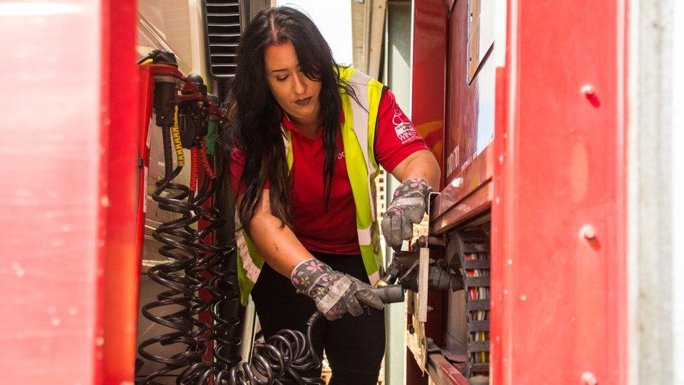 Leonie John attaching hydraulic cables between her cab and trailer