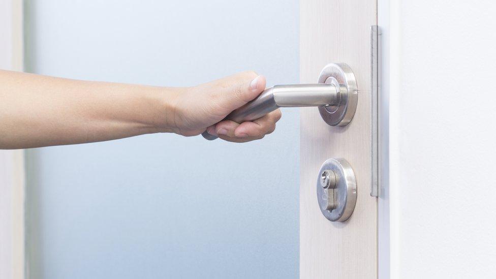 Hand on door handle