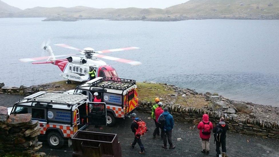 Llanberis Mountain Rescue safely stretcher a fallen walker to the coastguard helicopter below the summit of Snowdon