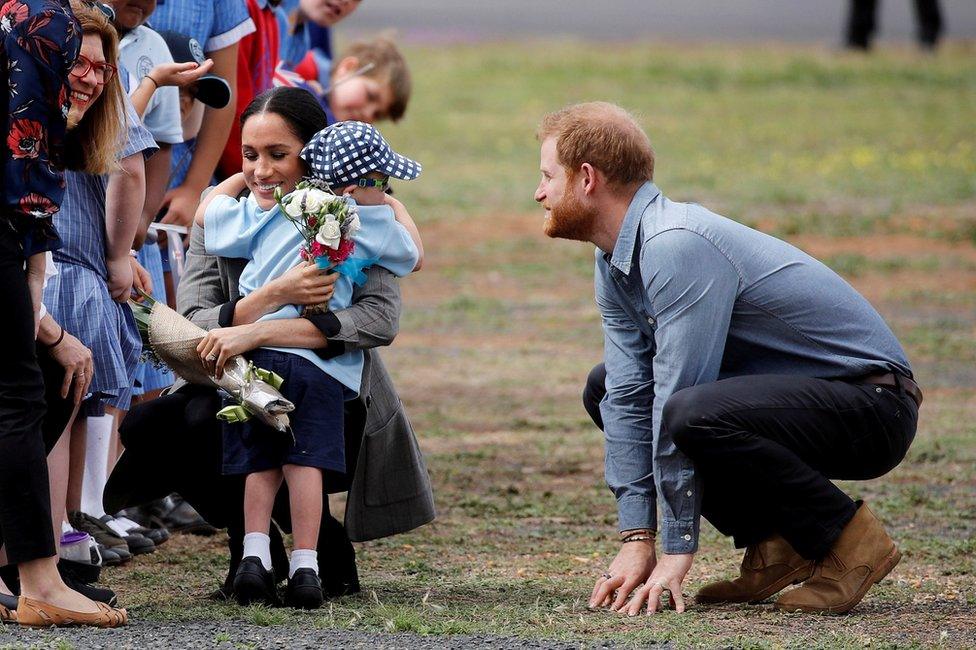 Prince Harry and Meghan, Duchess of Sussex, with a child at Dubbo airport, Dubbo, Australia, October 17, 2018