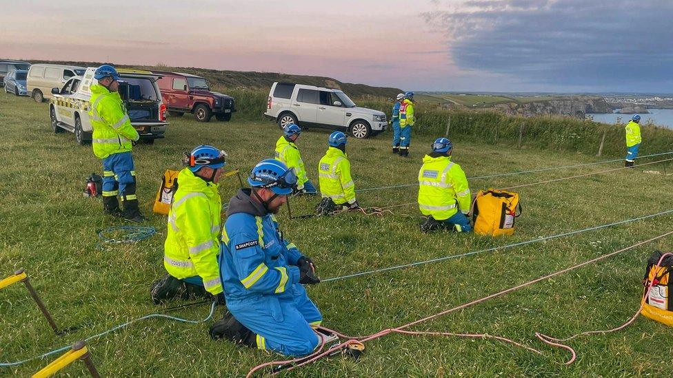 Coastguard rescue teams on cliff top