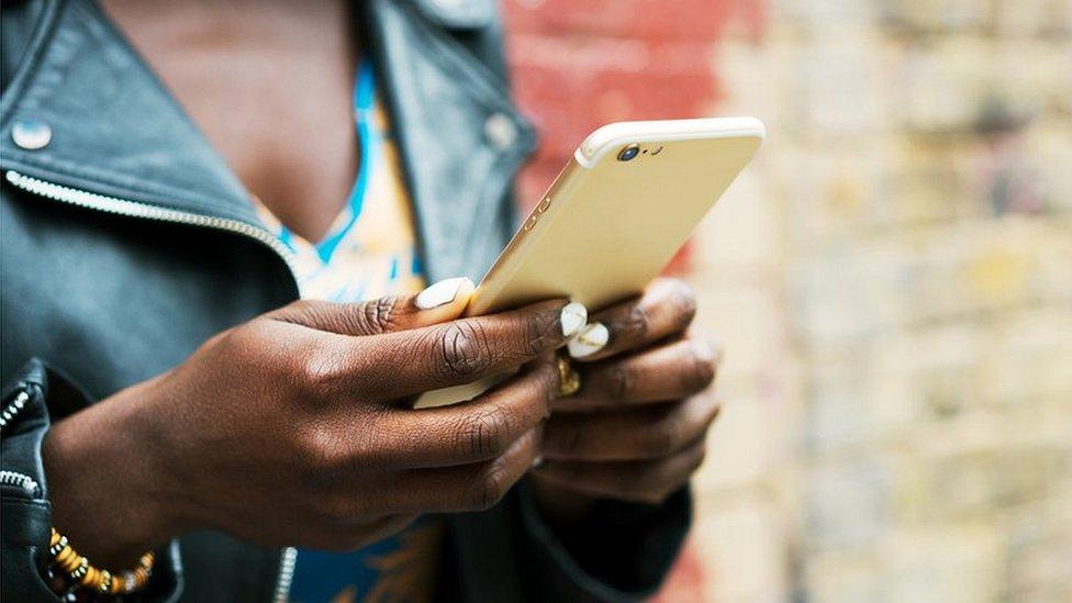 woman holding phone