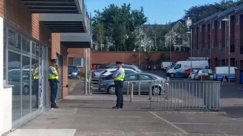 Gardaí standing outside the apartments in the Elderwood complex where the girl was found